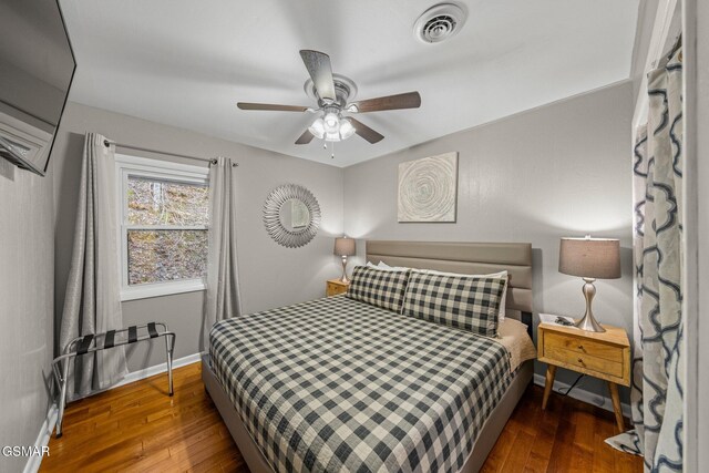 bedroom featuring dark hardwood / wood-style flooring and ceiling fan