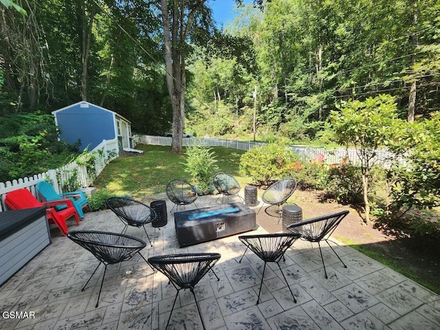 view of patio with a hot tub and a shed