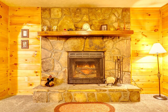 room details with wooden walls, a fireplace, and carpet floors