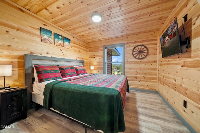 bedroom with wood walls, hardwood / wood-style floors, and wooden ceiling