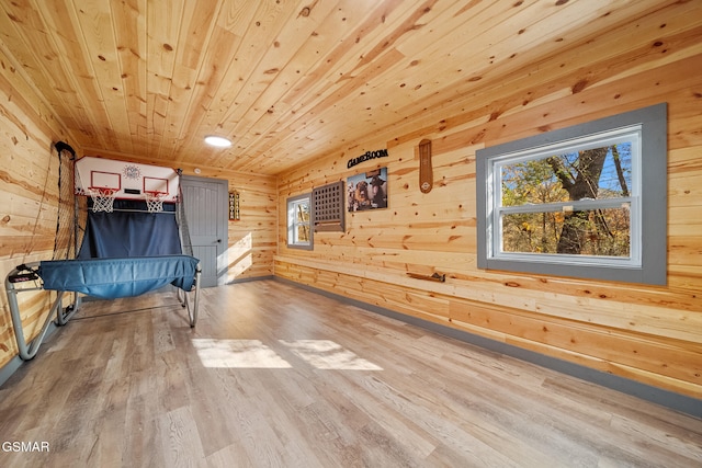 unfurnished bedroom featuring wooden walls, hardwood / wood-style flooring, and wooden ceiling