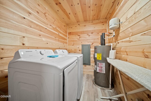 washroom with wood walls, electric water heater, wooden ceiling, light hardwood / wood-style flooring, and separate washer and dryer