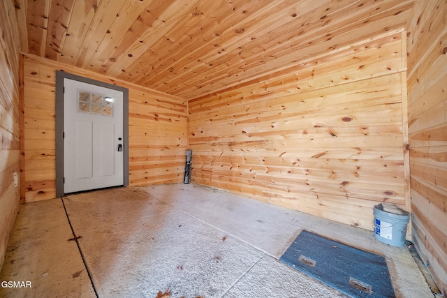 spare room featuring wood walls and wood ceiling