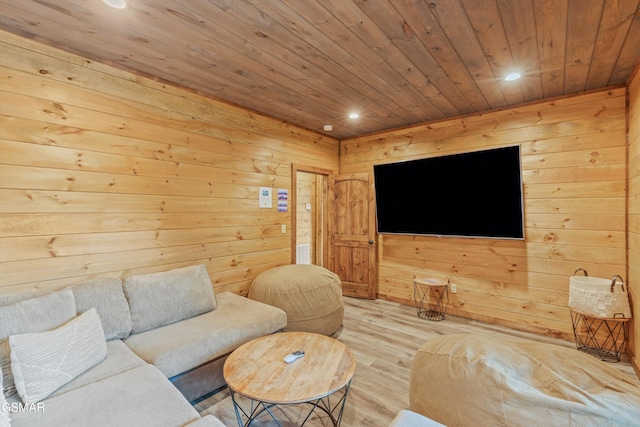 living room with wood walls, wooden ceiling, and light hardwood / wood-style flooring