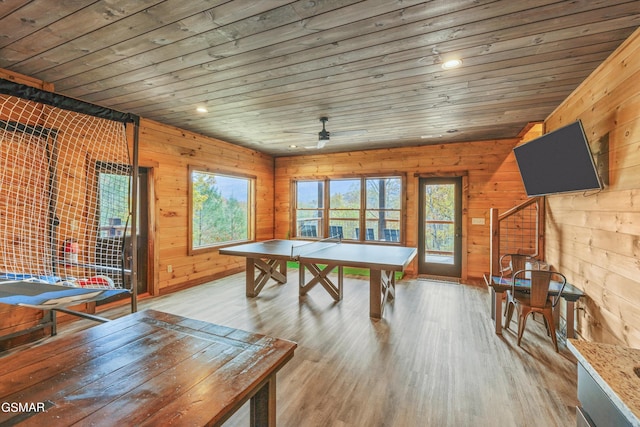 rec room with ceiling fan, light hardwood / wood-style flooring, and wood ceiling