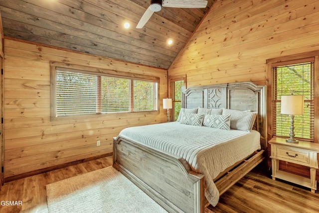 bedroom featuring hardwood / wood-style floors, vaulted ceiling, wooden ceiling, and wood walls