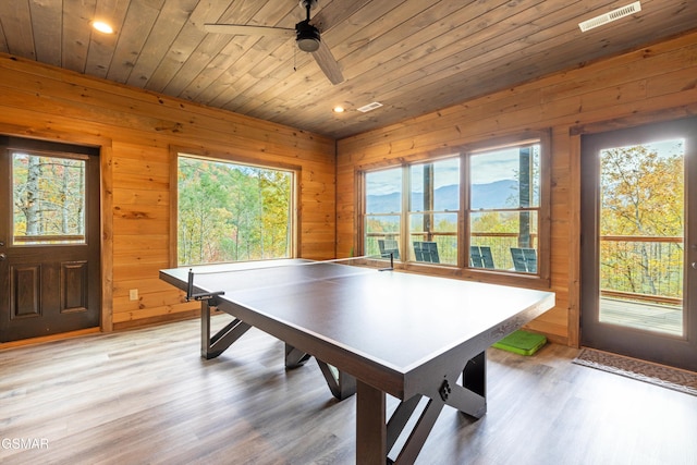 playroom featuring wood ceiling, ceiling fan, wooden walls, a mountain view, and hardwood / wood-style floors