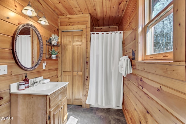 bathroom featuring a shower with curtain, wood ceiling, wood walls, and vanity