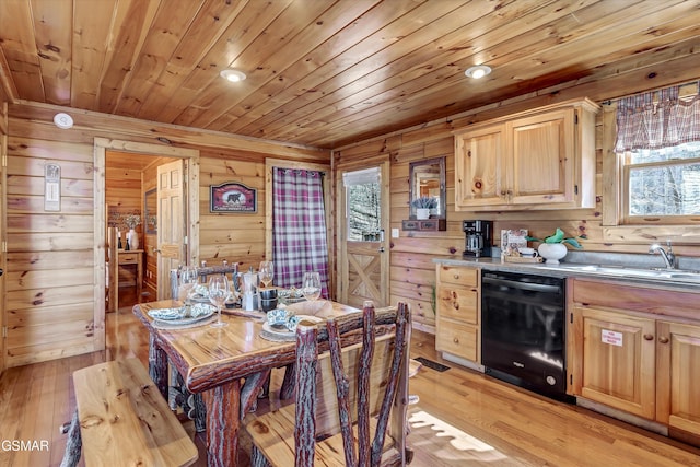 kitchen featuring black dishwasher, light brown cabinetry, light wood-style floors, wood ceiling, and a sink