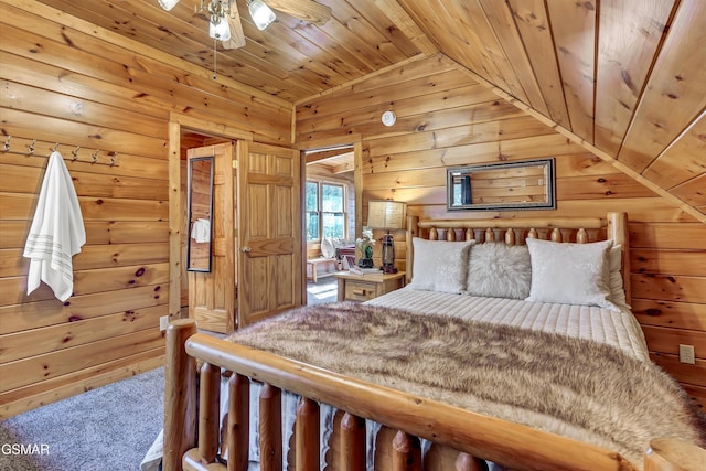 carpeted bedroom with vaulted ceiling, wooden ceiling, and wood walls