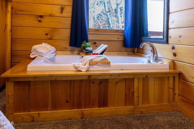 bathroom featuring a garden tub and wood walls