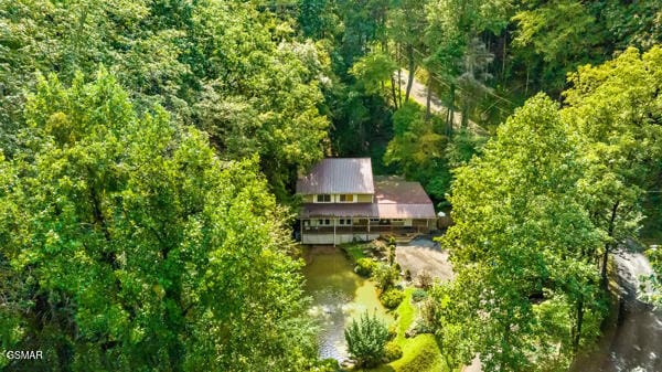 drone / aerial view featuring a wooded view