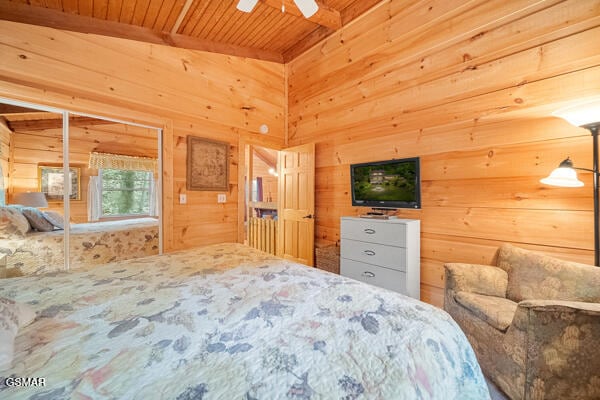 bedroom featuring wood ceiling and wooden walls