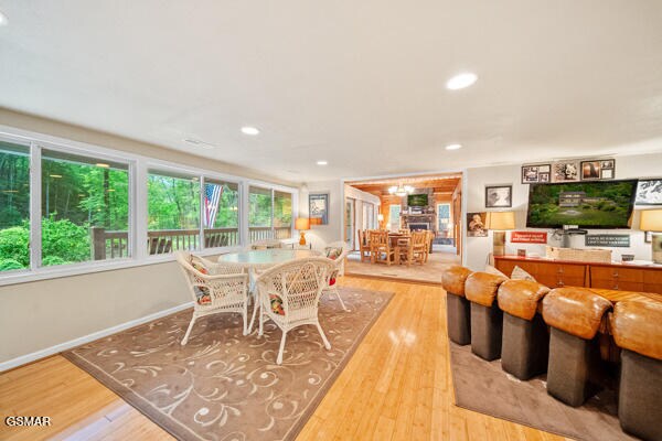 dining room featuring baseboards, light wood-type flooring, and recessed lighting