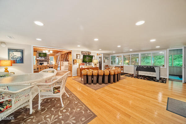 dining area featuring a wealth of natural light, a fireplace, recessed lighting, and wood finished floors