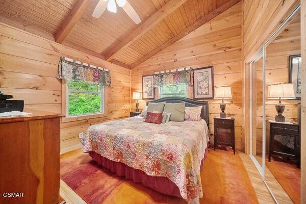 bedroom featuring wood ceiling, wood walls, lofted ceiling with beams, and wood finished floors