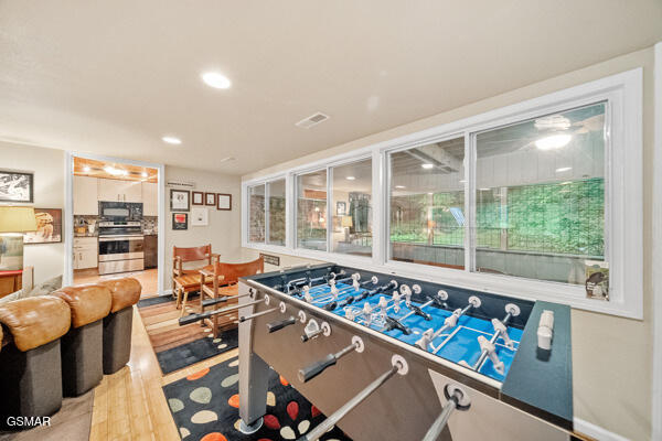 rec room with visible vents, wood finished floors, and recessed lighting