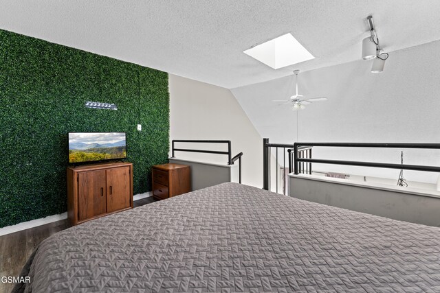 1260 Ski View Dr Unit 3308, Gatlinburg, TN 37738 - bedroom featuring a textured ceiling, an accent wall, wood finished floors, baseboards, and lofted ceiling with skylight
