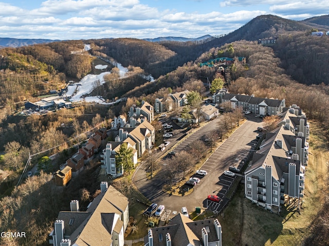 birds eye view of property featuring a residential view, a wooded view, and a mountain view