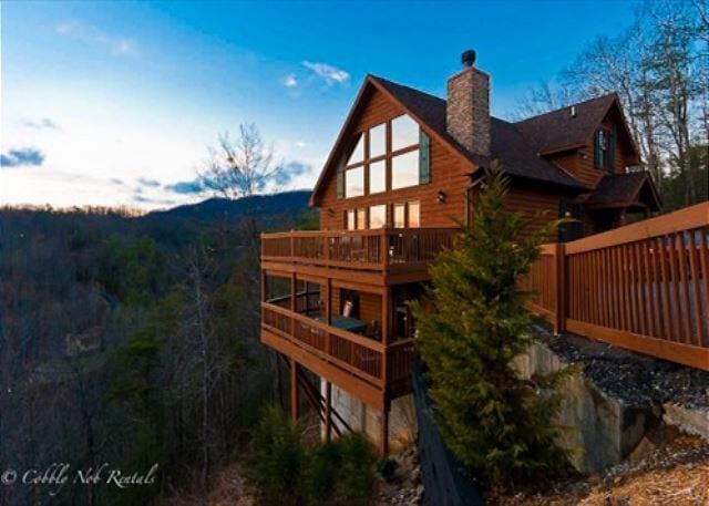 back of house featuring a wooden deck