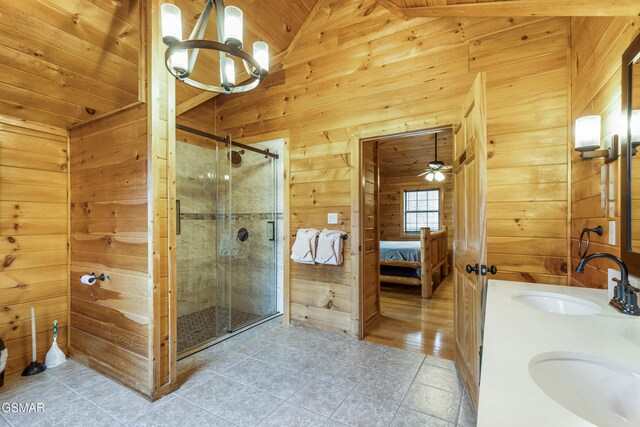ensuite bathroom featuring a sink, ensuite bath, wooden walls, and a shower stall