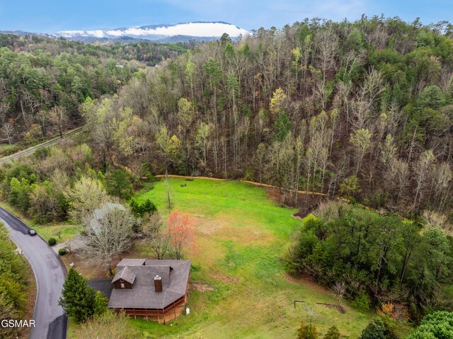 drone / aerial view featuring a forest view