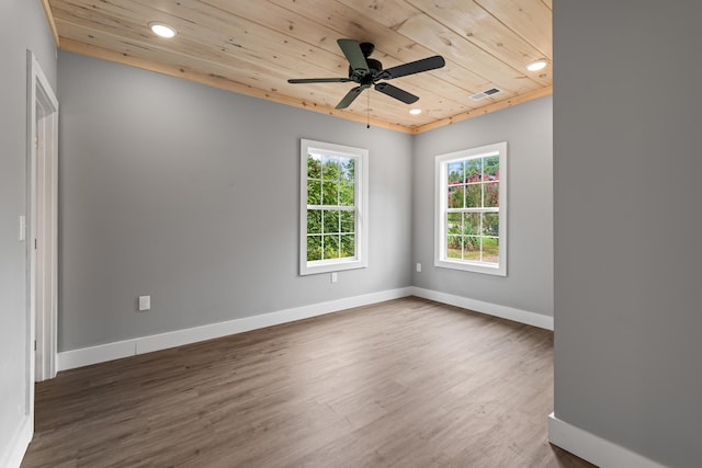 empty room with wood ceiling, ceiling fan, and dark wood-type flooring