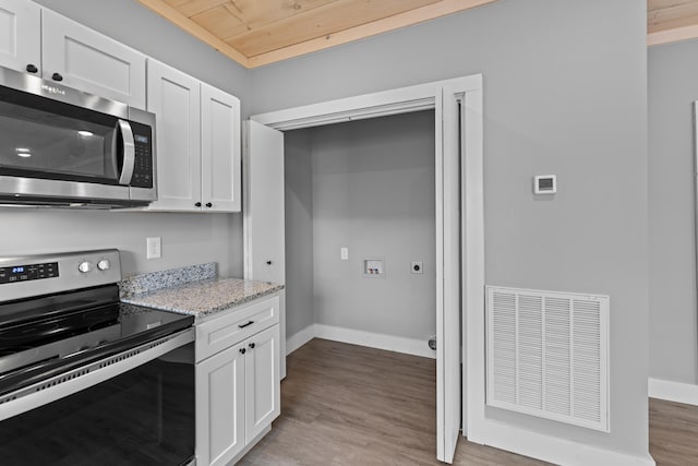 kitchen featuring white cabinetry, light stone countertops, stainless steel appliances, and light hardwood / wood-style floors