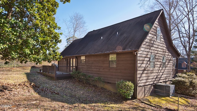 view of side of home featuring central AC unit and a deck