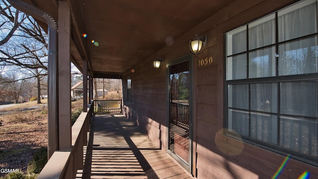 wooden terrace featuring covered porch