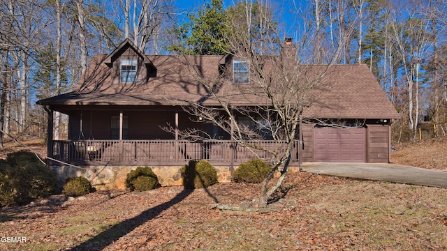 view of front of house featuring a porch and a garage