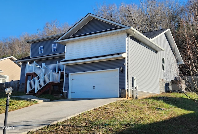 view of front of house with a garage and a front lawn