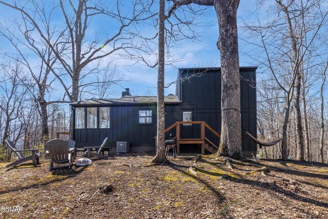 2760 Hawks View Trl, Pigeon Forge, TN 37876 - back of house featuring a chimney, central air condition unit, and board and batten siding