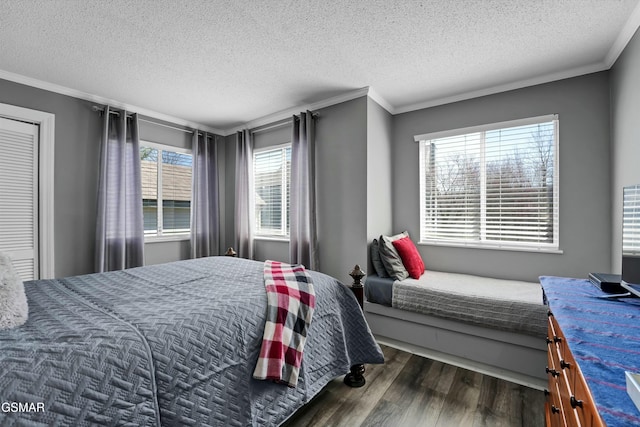 bedroom featuring dark hardwood / wood-style floors, a textured ceiling, and ornamental molding