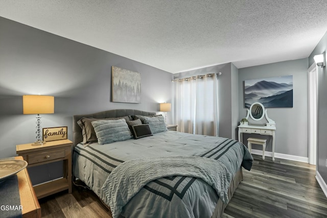 bedroom with dark hardwood / wood-style floors and a textured ceiling