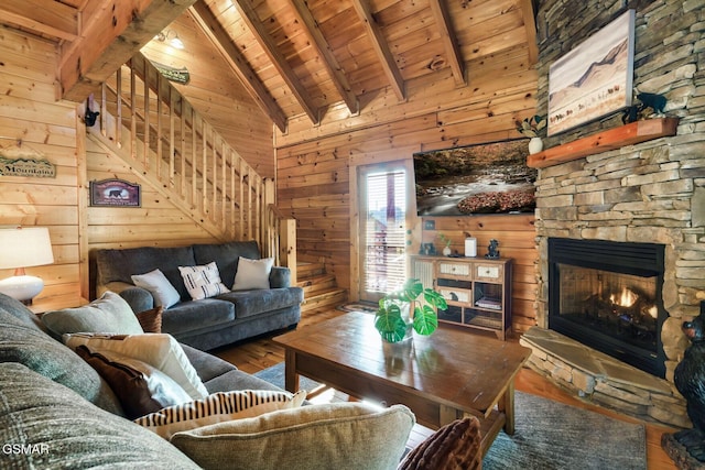 612 Cherry Blossom Way, Pigeon Forge, TN 37863 - living room with a fireplace, lofted ceiling with beams, wooden ceiling, wooden walls, and hardwood / wood-style flooring