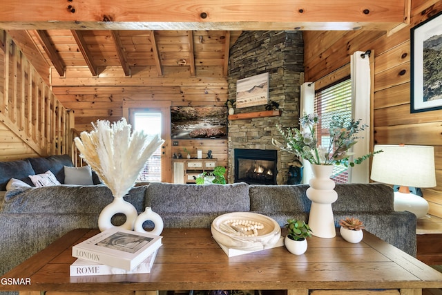 612 Cherry Blossom Way, Pigeon Forge, TN 37863 - living area with wooden ceiling, wooden walls, a stone fireplace, and vaulted ceiling with beams