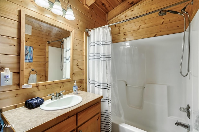 612 Cherry Blossom Way, Pigeon Forge, TN 37863 - bathroom with shower / tub combo with curtain, visible vents, wooden walls, vanity, and vaulted ceiling