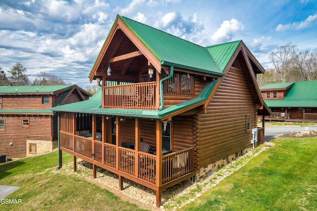 612 Cherry Blossom Way, Pigeon Forge, TN 37863 - back of property featuring metal roof, log exterior, and a lawn