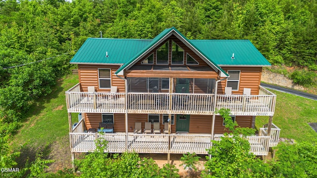 1792 Paulas Huskey Cir, Sevierville, TN 37876 - back of property featuring faux log siding, a deck, a forest view, metal roof, and a sunroom