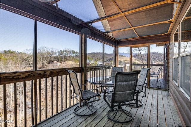 unfurnished sunroom featuring a mountain view