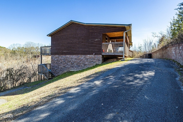 view of side of property with faux log siding