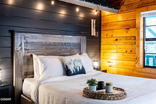bedroom featuring wooden walls