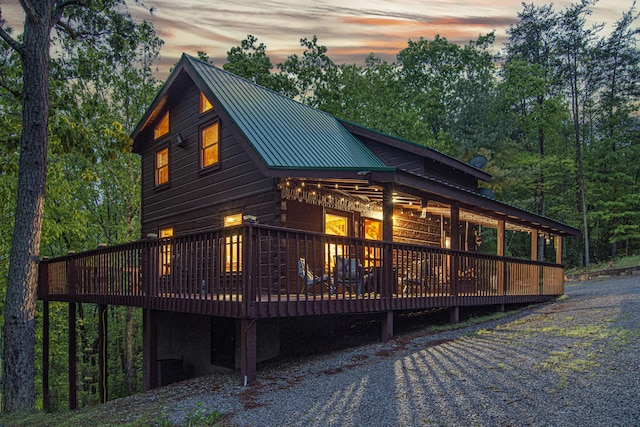 property exterior at dusk featuring a deck