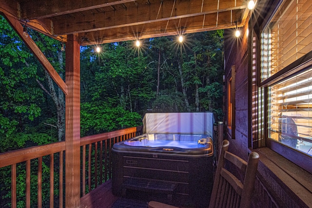 wooden deck with a hot tub
