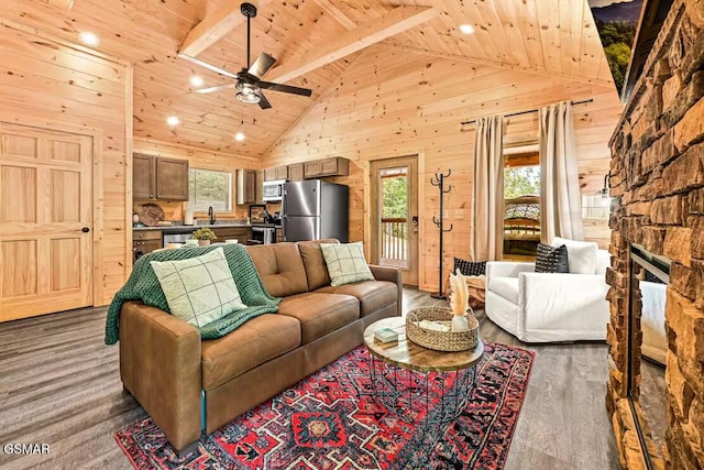 living room with wood ceiling, ceiling fan, high vaulted ceiling, beamed ceiling, and wood walls