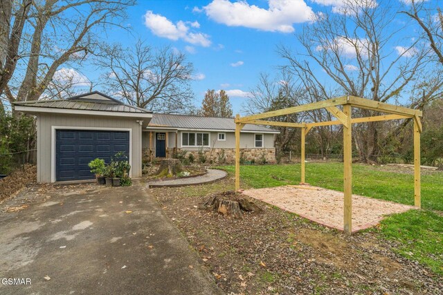 view of front of home featuring a front yard, a playground, and a garage