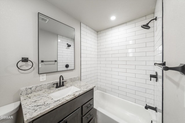 full bathroom with tiled shower / bath combo, toilet, and vanity