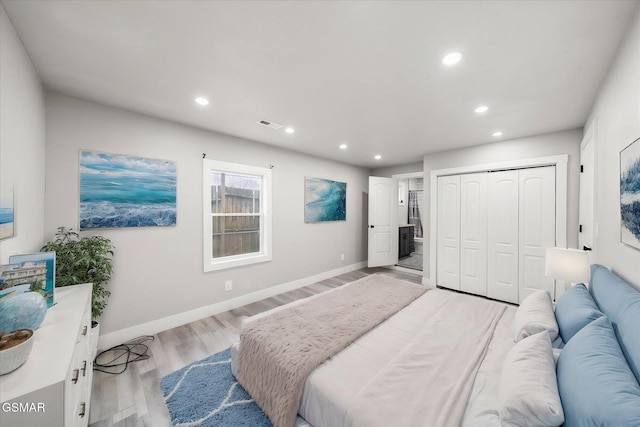 bedroom with a closet and light hardwood / wood-style flooring