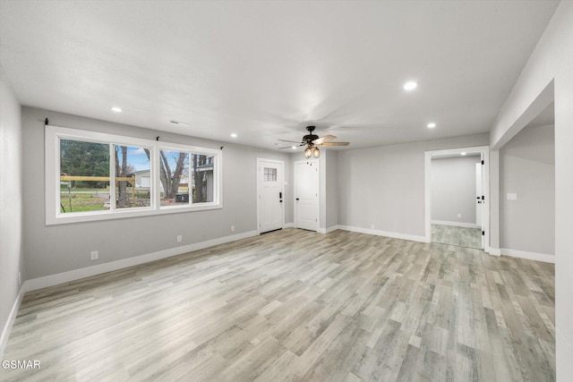 unfurnished living room with ceiling fan and light hardwood / wood-style floors